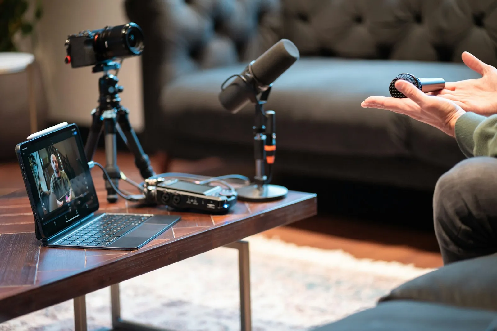 Podcast recording equipment and microphones around a studio interview.